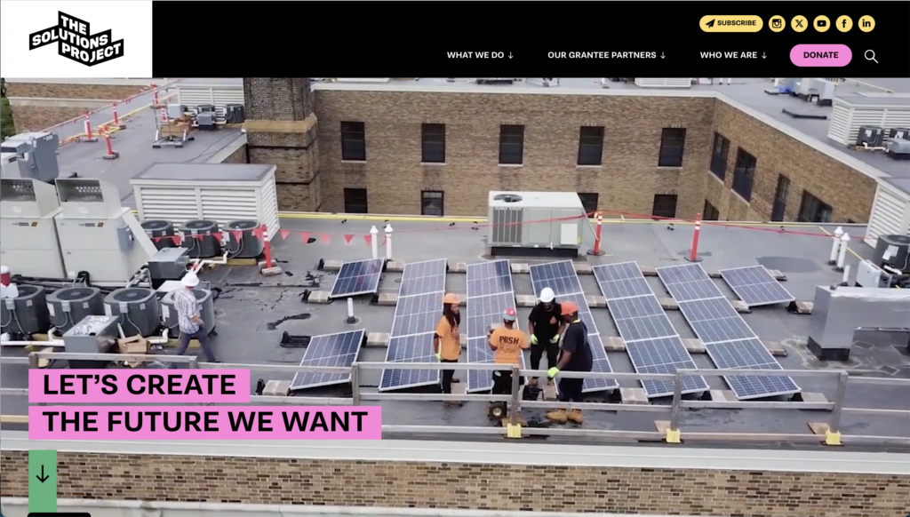 People installing solar panels on a building rooftop